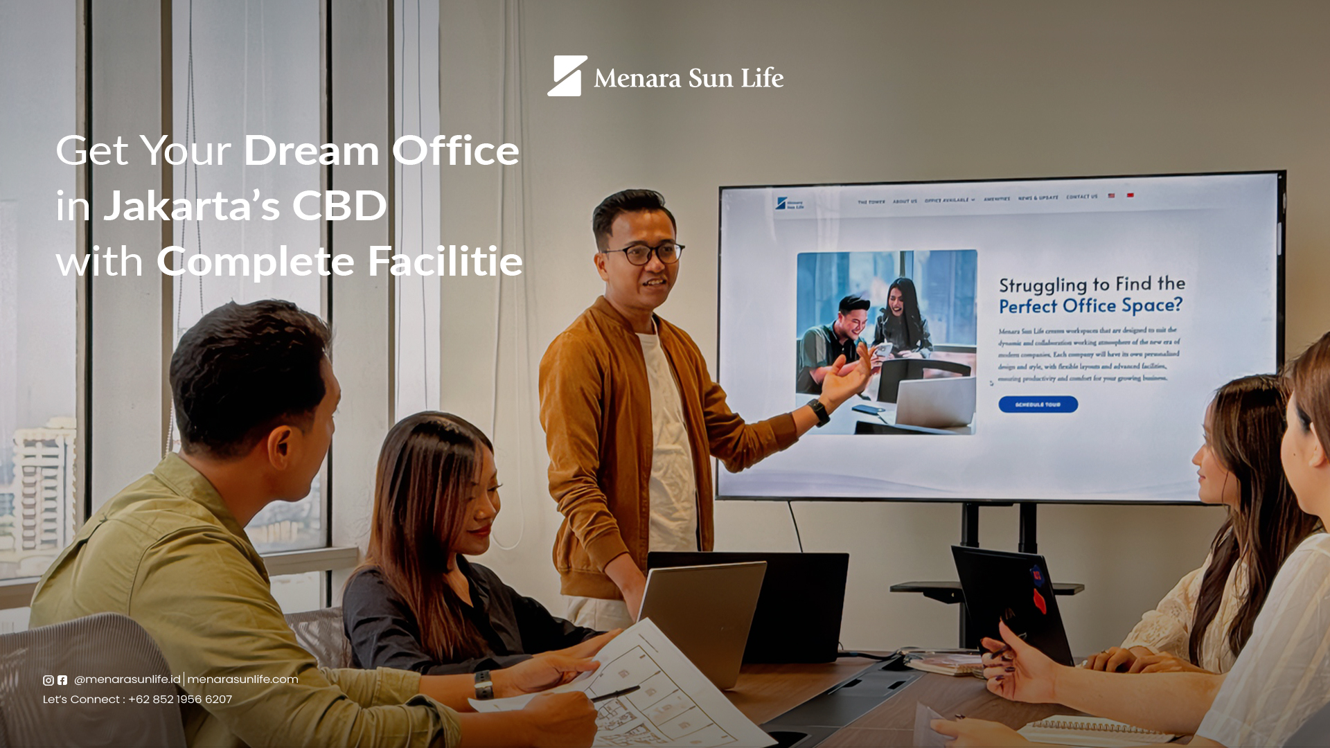 A professional team discussing office plans in a modern meeting room at Menara Sun Life, highlighting complete facilities in Jakarta’s CBD.