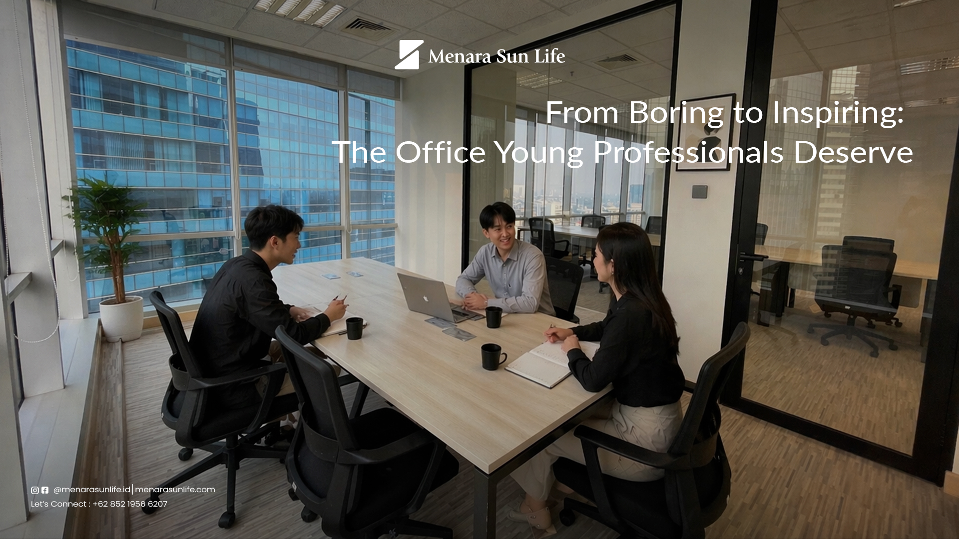 A group of young professionals engaged in a collaborative meeting in a modern office space at Menara Sun Life, with a city view.