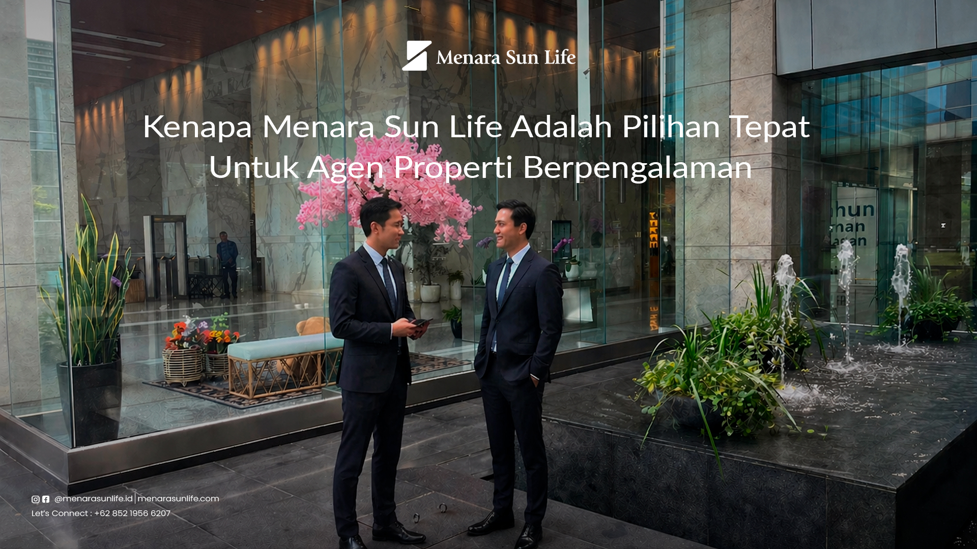 Two real estate agents in suits conversing in the luxurious lobby of Menara Sun Life, showcasing the building's suitability for experienced professionals.